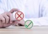 Hand holding false symbol