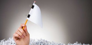 XLMedia gets out of the affiliate game, sells to Sportradar Hand raising white flag made of offic supplies