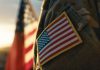 Solider with an American flag as DraftKings teams up with VetsInTech for a Memorial Day activation.
