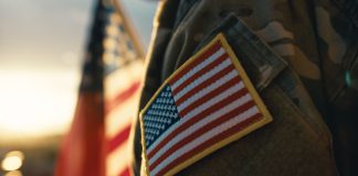 DraftKings offers Memorial Day promo to support veterans Solider with an American flag as DraftKings teams up with VetsInTech for a Memorial Day activation.