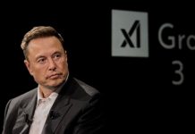 Elon Musk in front of the logo of xAI, which has partnered with prediction markets platform Kalshi
