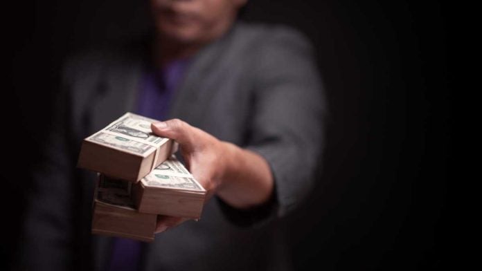 Hand passing along cash, which is what High 5 will do as a part of a settlement with the state of Connecticut