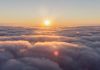 Sun peering over clouds as concept for a new beginning of payments by Approvely