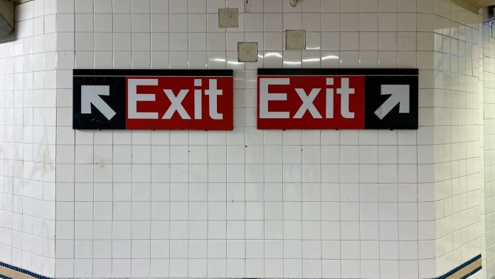 Exit signs in a New York City subway, the kid that VGW might follow on its way out of the state