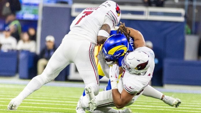 Arizona Cardinals player tackle an opponent