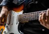 Guitar player holds instrument with Bragg Gaming securing a content deal with Hard Rock Bet.