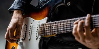 Guitar player holds instrument with Bragg Gaming securing a content deal with Hard Rock Bet.