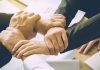 Free-market groups urge CFTC to continue allowing sports contracts Image of several hands clasping one another, indicating a coalition