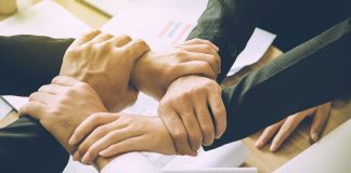Free-market groups urge CFTC to continue allowing sports contracts Image of several hands clasping one another, indicating a coalition