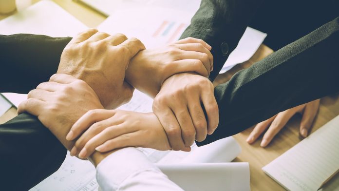 Image of several hands clasping one another, indicating a coalition