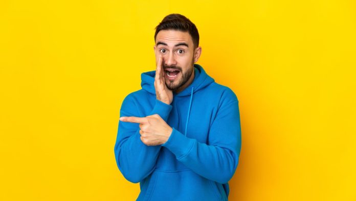 A man pointing, like Crypto.com is pointing to Kalshi being granted TROs