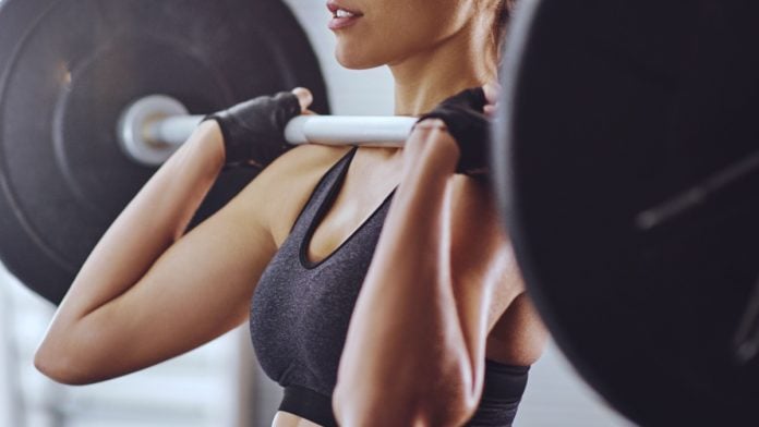 Kalshi-Funding-Round-2B-Valuation Woman lifts weight as Kalshi's valuation grows to $2 billion.