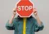 A stop sign is being held as BetOnline receives a cease and desist letter.