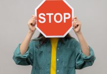 A stop sign is being held as BetOnline receives a cease and desist letter.