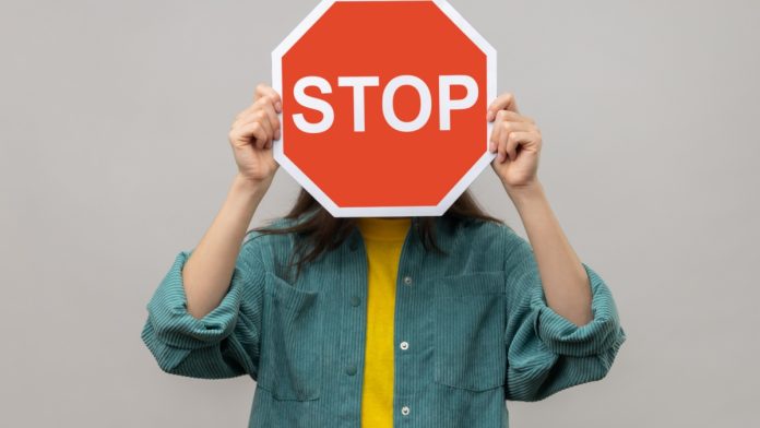 A stop sign is being held as BetOnline receives a cease and desist letter.