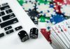 Computer with dice and deck of cards as Maine considers online casinos.