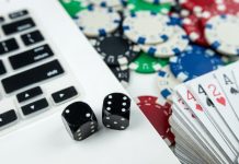 Computer with dice and deck of cards as Maine considers online casinos.