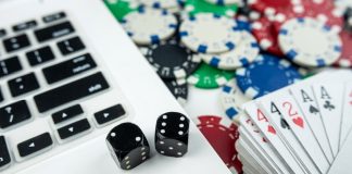 Computer with dice and deck of cards as Maine considers online casinos.