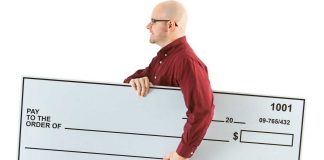 Social gaming company acquires Publishers Clearing House for $7M A person holds a blank check representing the Publishers Clearing House.