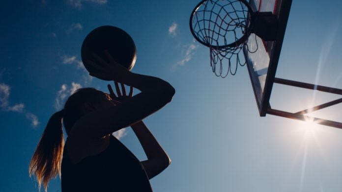 Women's basketball player attempts a shot as BetMGM and Monumental Sports bring an interactive viewing experience to fans.