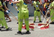 Cleaning crew with brooms