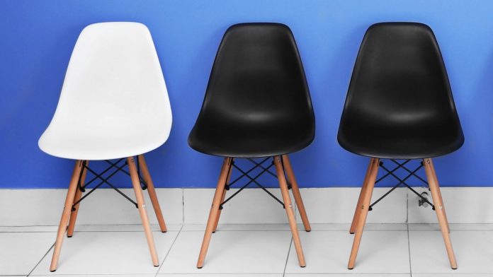 Two black chairs and one white chair, illustrating how PENN has filled two of the board seats HG Vora pushed for