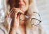 Woman handles eye glasses as PlayAIO shares visibility data on online casino games.