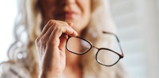 PlayAIO provides monthly insights of most visible online casino games Woman handles eye glasses as PlayAIO shares visibility data on online casino games.