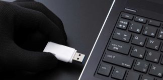 PrizePicks sues former employee who defected to DraftKings Gloved hand with flash drive symbolizing corporate espionage