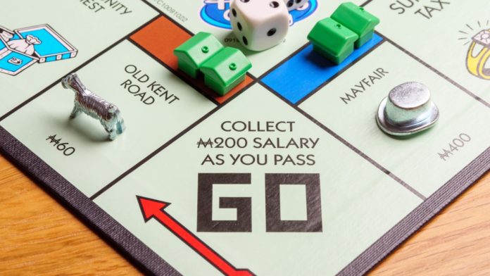 A monopoly board is being played as Rhode Island will maintain a sports betting monopoly in the state.