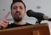 Angry man speaks into microphone