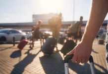 People carry their bags for a trip as WOW Vegas plans to exit Louisiana.