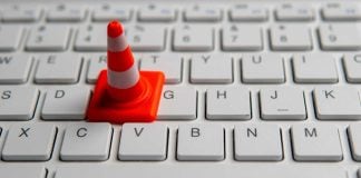 Traffic cone on keyboard representing the tech difficulties that led WSOP to cancel an online poker tournament