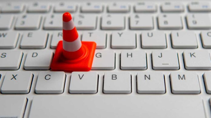 Traffic cone on keyboard representing the tech difficulties that led WSOP to cancel an online poker tournament