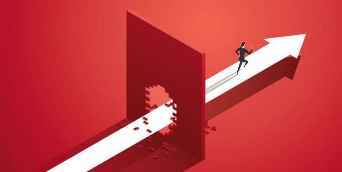 A man runs through a brick wall, much like Ontario's iGaming market surpasses expectations.
