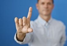 A man wagging his finger in a "no" gesture