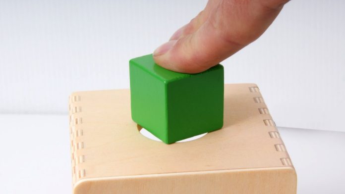 A person trying to fit a square peg in a round hole