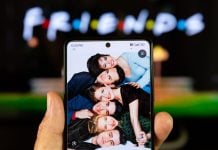 A photo of the Friends cast with the show's logo in the background