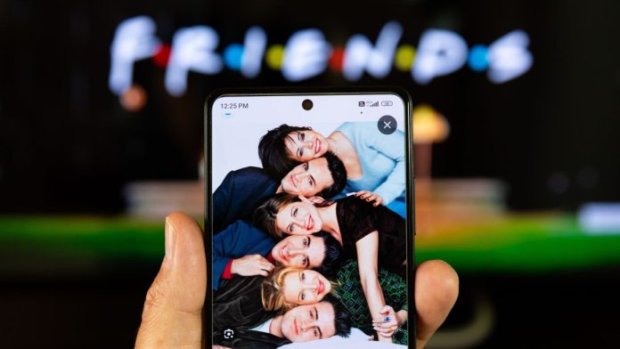 A photo of the Friends cast with the show's logo in the background