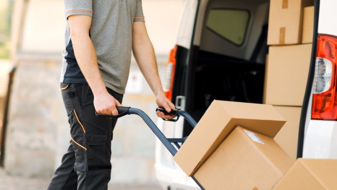 A delivery man handles packages as Bragg Gaming delivers new games to Fanatics Casino.