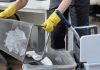 Janitor emptying office waste basket