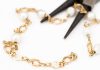 Pliars cutting up gold bracelet