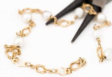Pliars cutting up gold bracelet