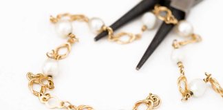 Pliars cutting up gold bracelet