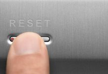 Finger pressing reset button