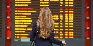 Delayed flight grounds Senate committee’s Quintenz CFTC vote A woman looking at a board of flight departures