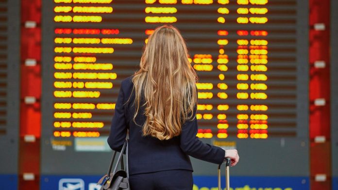 Delayed-flight-grounds-Senate-committee's-Quintenz-CFTC-vote A woman looking at a board of flight departures