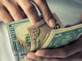 A hand of money as FanDuel received fines from Iowa's gaming regulator.