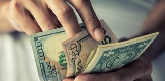 Iowa regulator fines FanDuel $125K for multiple violations A hand of money as FanDuel received fines from Iowa's gaming regulator.