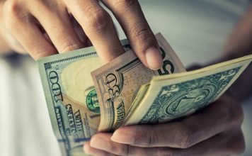 A hand of money as FanDuel received fines from Iowa's gaming regulator.